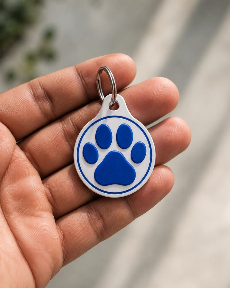 3D-printed NFC tag with blue paw-print design, held in hand