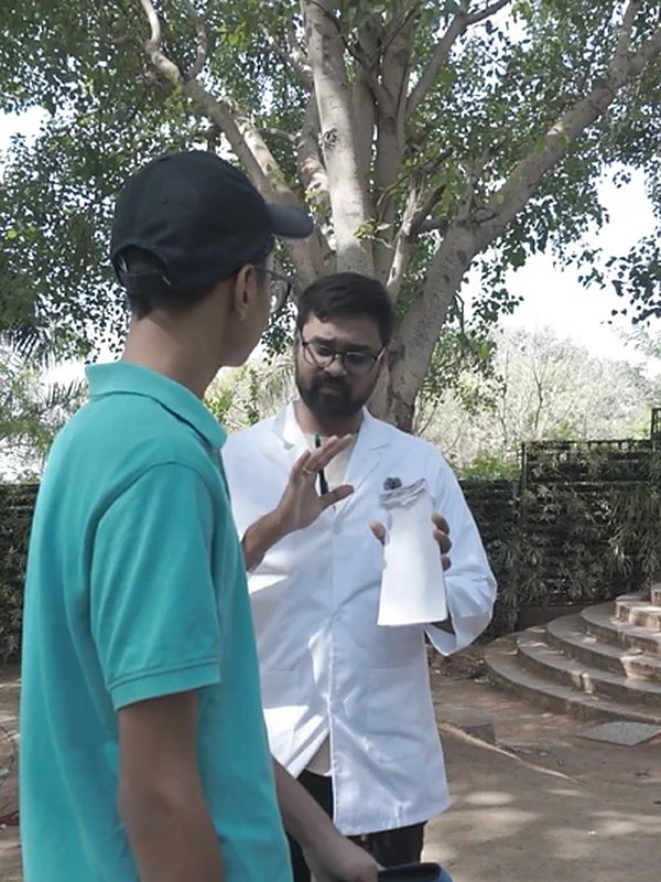 A vet in a white coat talking with a young dog parent at the free vet consultation