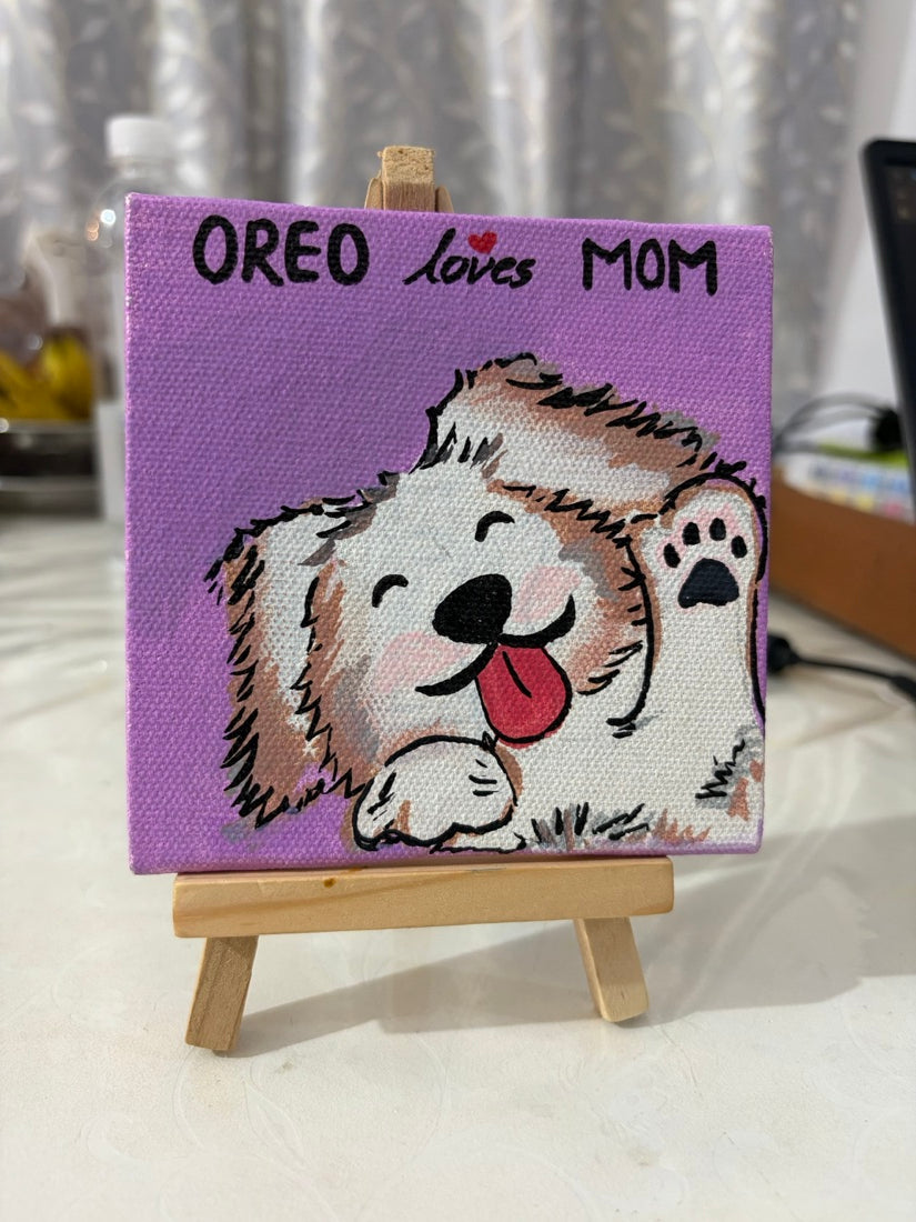 Hand-painted canvas reading Oreo loves Mom on a wooden easel